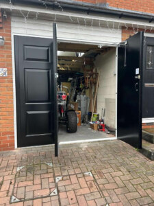 Bi folding insulated side hinged garage doors open except access door